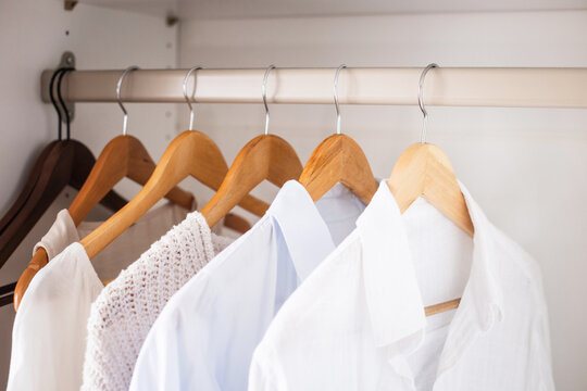 White shirts on hangers in closet, orderly display