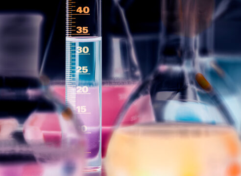 Colorful liquid fills laboratory glassware during an experiment
