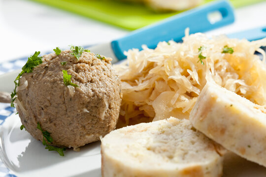 Plate of bread and liver dumpling with sauerkraut, close up