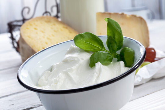 Yoghurt and cheese on table