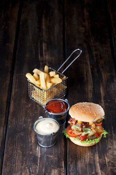 Large hamburger with fries, mayonnaise and ketchup