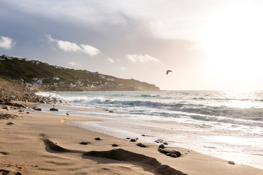 Waves crash on the sandy beach at Whitesand Bay in Cornwall