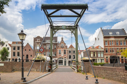 Historic iron mouter bridge over a scenic traditional canal in Delfshaven, Rotterdam, Netherlands