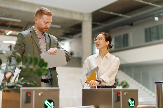 Businessman and businesswoman enter the office building