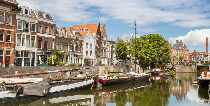 Panorama of traditional historic ships along the scenic canal of Delfshaven, Rotterdam, Netherlands