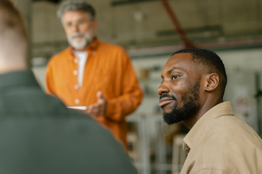 Man listening to colleague during a business meeting in the office
