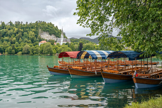 A traditional wooden Pletna boat floats on Lake Bled in Slovenia