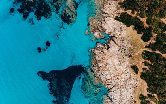 Aerial view of rocky coastline and turquoise sea at a summer resort