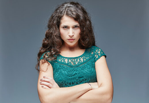 Portrait of angry young woman with crossed arms