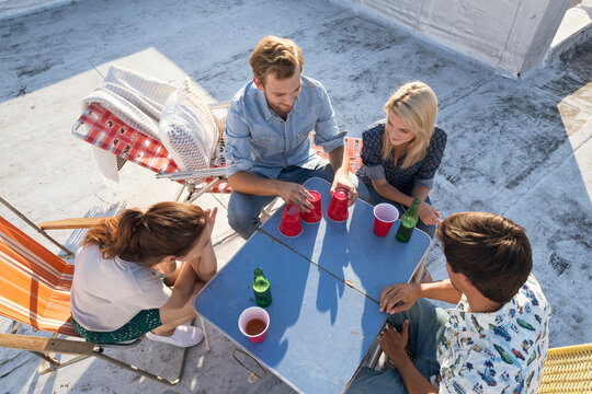 Friends having a rooftop party on a beautiful summer evening