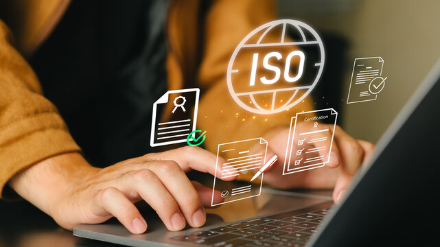 ISO certification and compliance with quality standards; reviewing certification documents on a laptop; performance audits; and process improvements for certification and accreditation.
