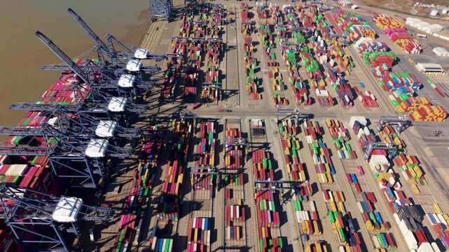 Low altitude drone push shot showing cargo loading operations on a container ship at Port of Felixstowe