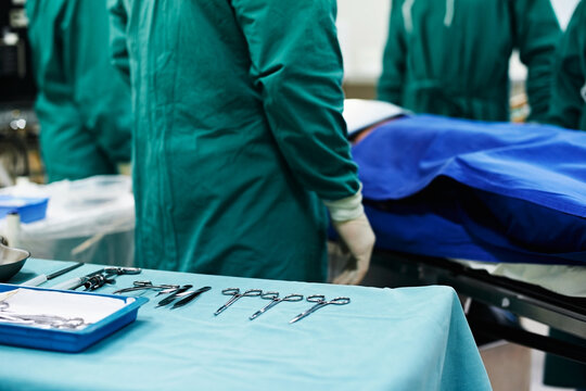 Theater, doctors and medical tools for surgery procedure, gastric bypass and operating precision. Surgeon team, people and scissors in ER for gastrectomy operation, sterile instruments and healthcare