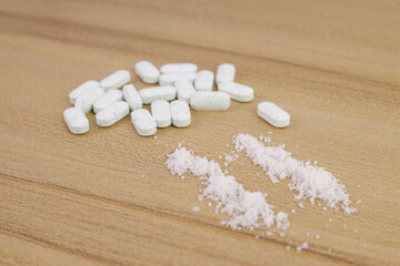 Fototapeta premium Close Up of Crushed Powder Lines and Oval Medical Tablets