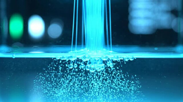 Macro Video of Optical Fibers Dipping Into Water with Bubbles and Light Transmission in a Dynamic Fluid Environment