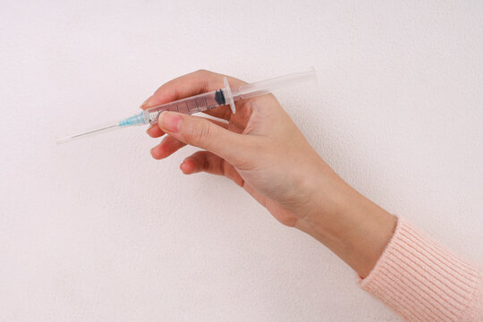 Hand Holding Medical Syringe