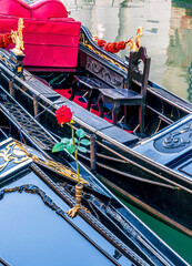 gondolas in venetian canal decorated in traditional vintage style of Venice and old architecture buildings on background © Yaroslav