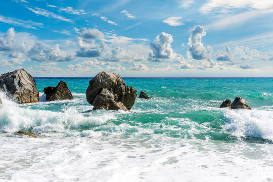 Dramatic seascape on golden sand coast with clouds during morning or evening. Dramatic day over the sea with blue clouds and turquiose sea surf