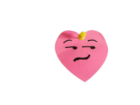 Pink heart shaped sticky note with a funny smirk face