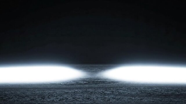 Bright white spotlights illuminating dark wet asphalt road surface during dramatic night rain motion footage animation for creative background design