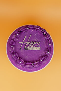 Purple birthday cake celebrating happy birthday wishes