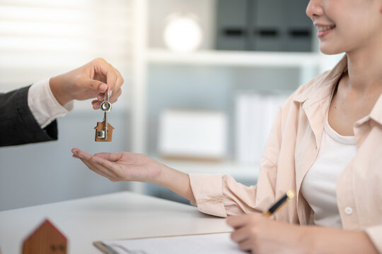 lease, rental and selling home. Real estate agent manager smile holding key for new owner. rent house, Sales, loan credit financial, insurance, Seller, dealer, installment,  buy, sell, move in