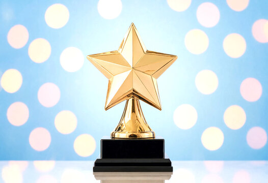 Golden star trophy award on a black base with colorful bokeh lights background perfect for success celebration
