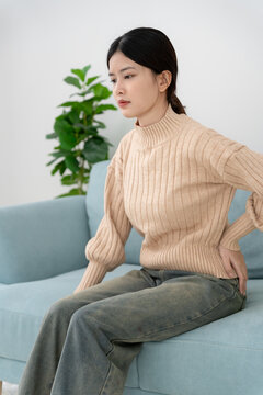 woman holding back while and suffer from unbearable pain health and problems, chronic back pain, backache in office syndrome, scoliosis, herniated disc, muscle inflammation