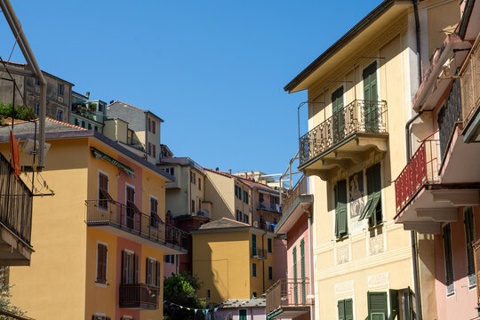 View of colorful historic buildings with balconies and shutters in the village of Manarola, Liguria, Italy.