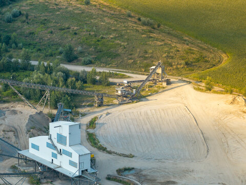 Aerial view of an active quarry site with conveyor belts and processing plant