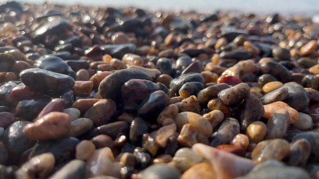 Relax and enjoy a sea vacation with colorful pebbles on the shore at a beach location