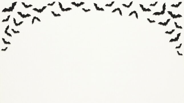 A festive halloween background featuring a top border of flying black bats on white space
