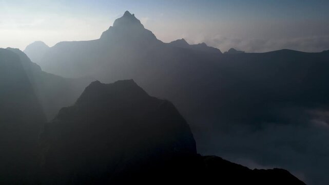 Aerial Scenery of Kelud Mountain Peak and Surrounding Volcanic Peaks Rising Above a Layer of Clouds in Morning Light. Dramatic Mountain Scenery in East Java, Indonesia.
