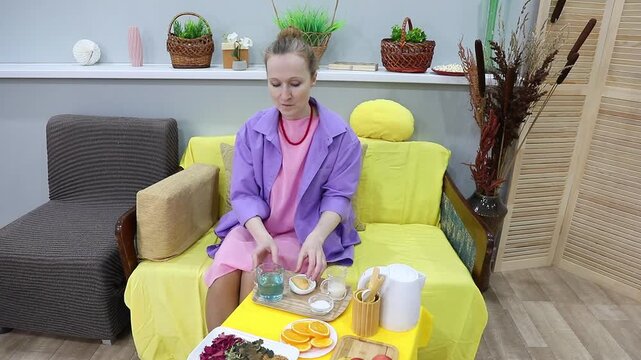 Woman drinking blue tea, pigeon wings