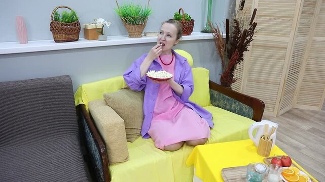 woman eating popcorn and talking