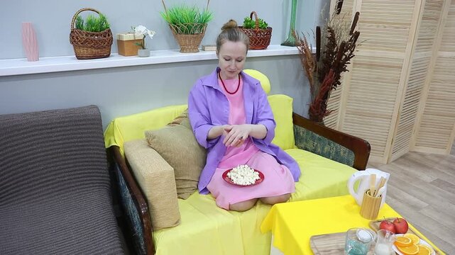 woman eating popcorn from a handful