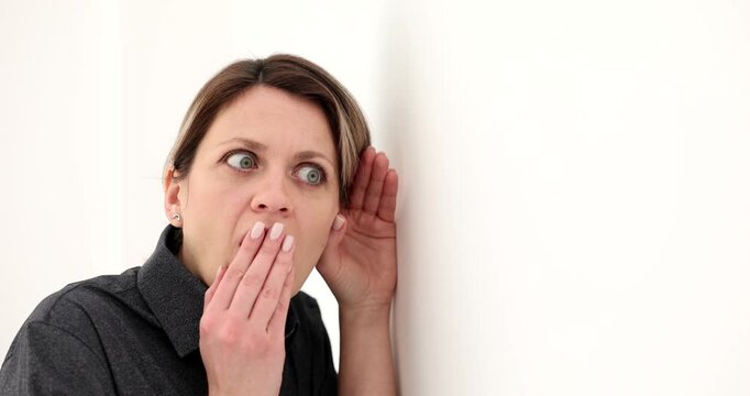 In a cozy room, a woman leans in with wide eyes, eager to hear. Her expression changes as she whispers and gasps, revealing a playful atmosphere filled with whispers and surprises.