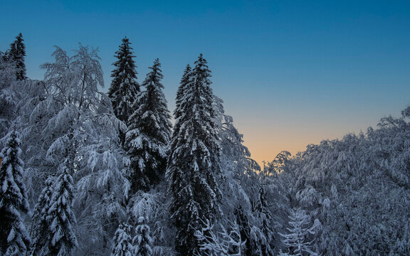 Suggestive winter sunset with orange and purple shades that light up the mountain top