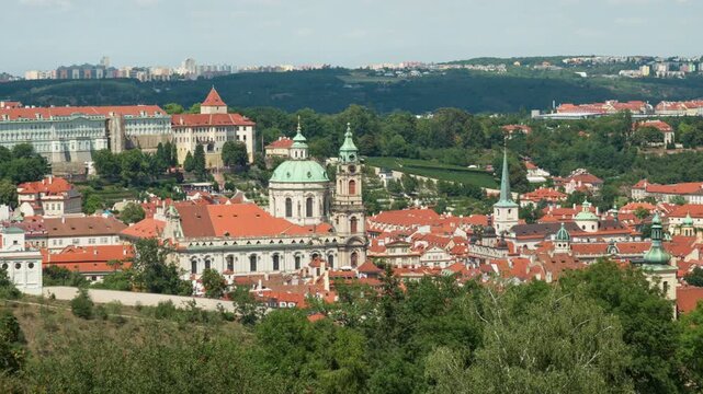 Panorama of Mala Strana district in Prague showcases historic roofs, St. Nicholas Church, and Prague Castle. A unique urban viewpoint away from Charles Bridge for travel editorial content.