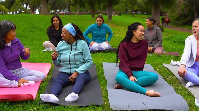 Group of happy multiracial women circle having fun together after yoga class outdoor - People with different body and age - Connection, sport and community concept
