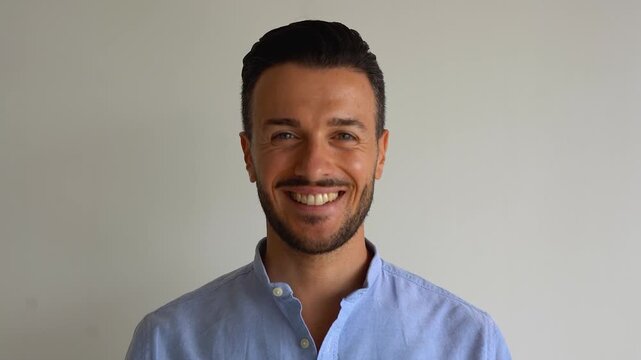 Young business man smiling on camera inside corporate office - Job, career and happiness concept