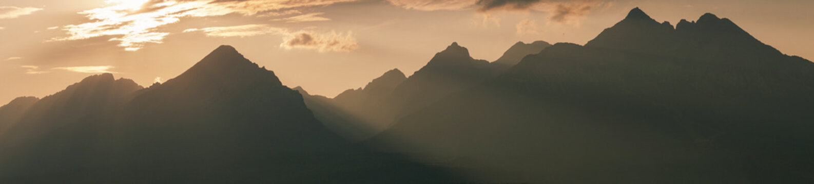 panoramic sunset silhouette of high tatras mountain range peaks including slavkovsky stit, lomnicky stit, kezmarsky stit in slovakia landscape view rocky summits concept of travel, tourism, nature