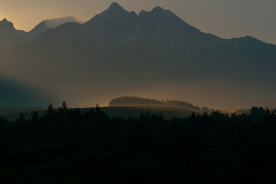 sunset silhouette of high tatras mountain range peaks including lomnicky stit, kezmarsky stit, and pysny stit in slovakia landscape view rocky summits