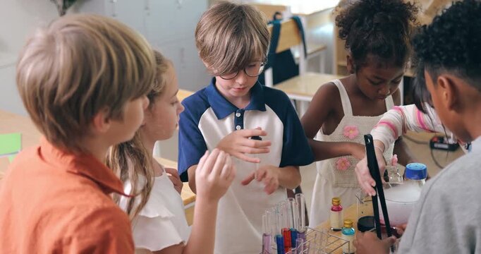 Diverse young children conduct a colorful chemistry experiment using test tubes and pipettes in a classroom.