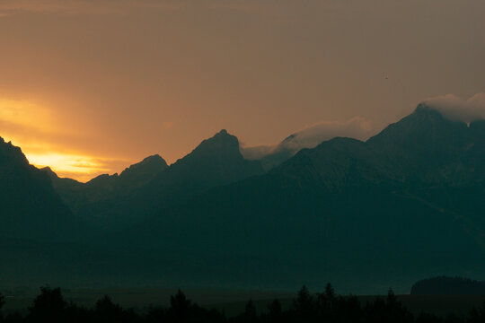 sunset silhouette of high tatras mountain range peaks lomnicky stit, kezmarsky stit, pysny stit in slovakia landscape view rocky summits concept of travel, tourism, nature