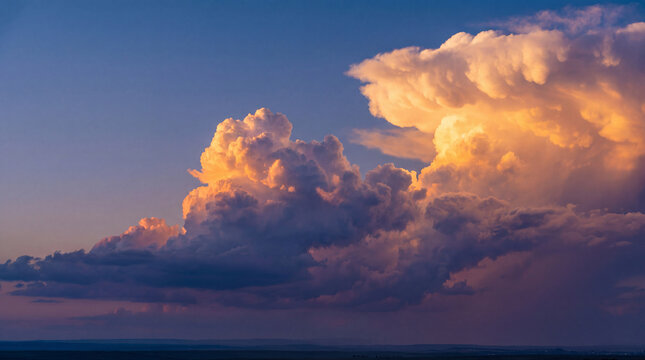Majestic cloudscape at sunset above a wide expansive landscape with dramatic cumulus formations and vivid colors.