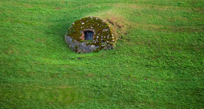 Mossy stone structure of the historic bunker creates a hidden shelter