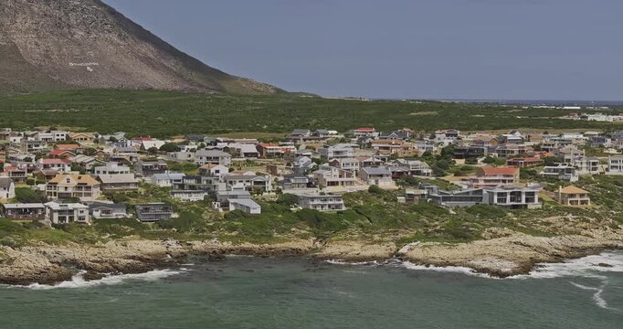 Gansbaai South Africa Aerial v29 telephoto low flyover around Stanford's Cove beach and De Kelders homes along the rocky shoreline - Shot with Mavic 3 Pro Cine - Jan 8th 2024