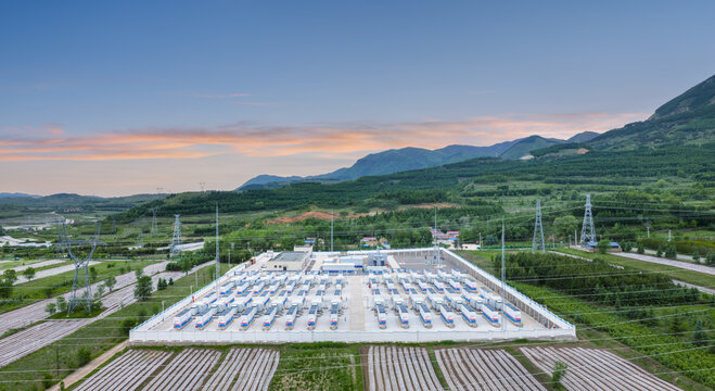 Aerial View of Grid-Side Energy Storage Station in Mountain Valley at Sunrise