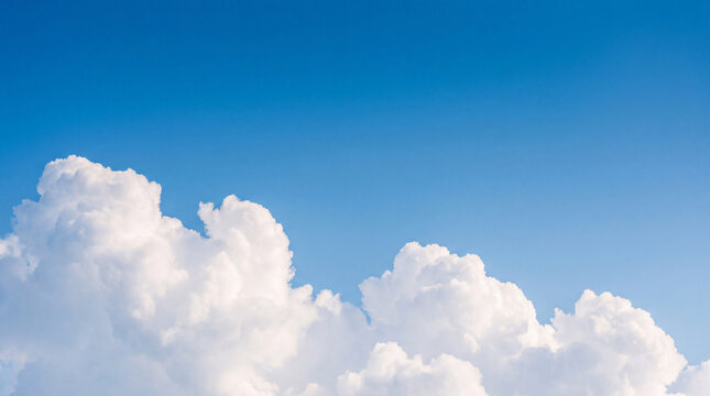 Bright blue sky with fluffy white cumulus clouds at the bottom, creating a serene and expansive view.